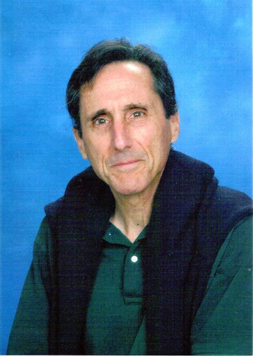 Bruce Silton, Author and Illustrator Portrait of author Bruce Silton in a green polo shirt with a navy sweater over his shoulders, against a blue background