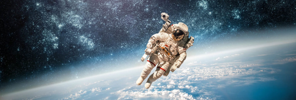 Astronaut floating in space above the Earth